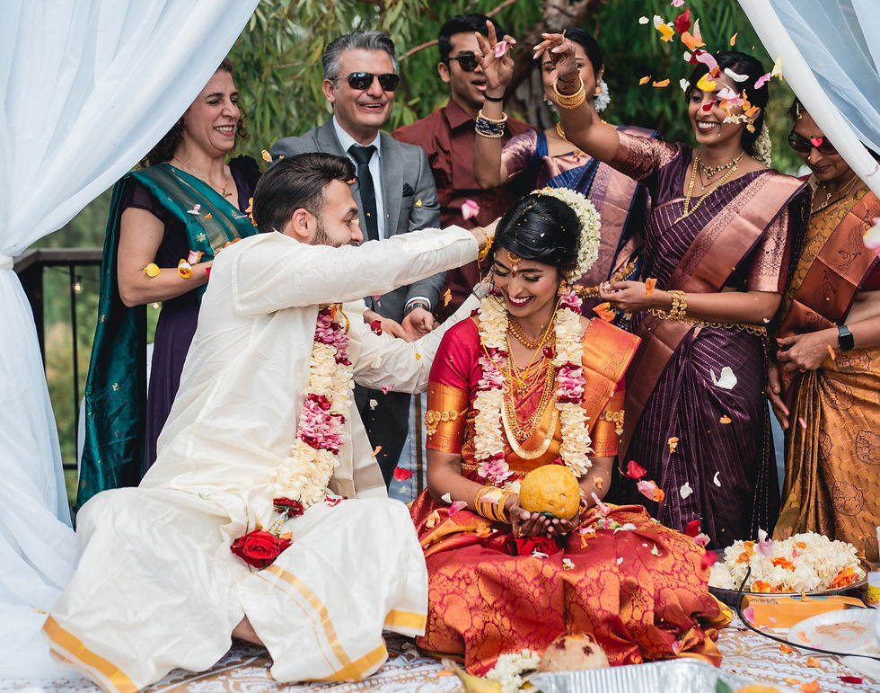 Tamil wedding ceremony. Groom tying taali around bride.