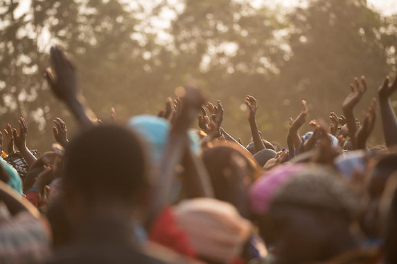 Large group of people with their hands in the air