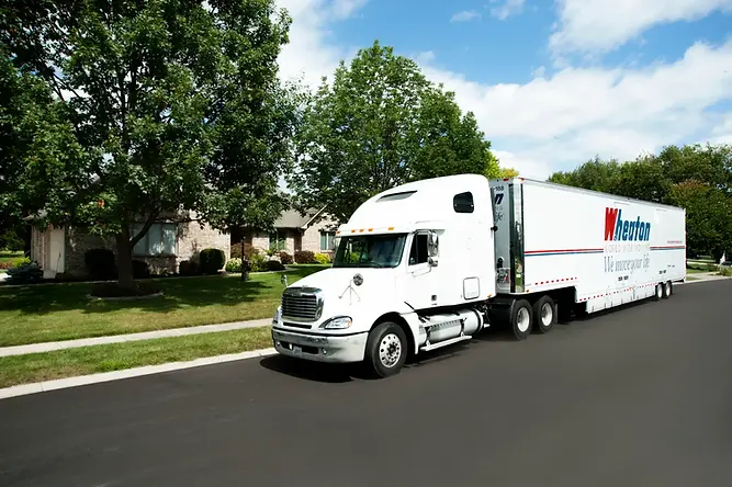 Wheaton tractor trailer in front of a customer home