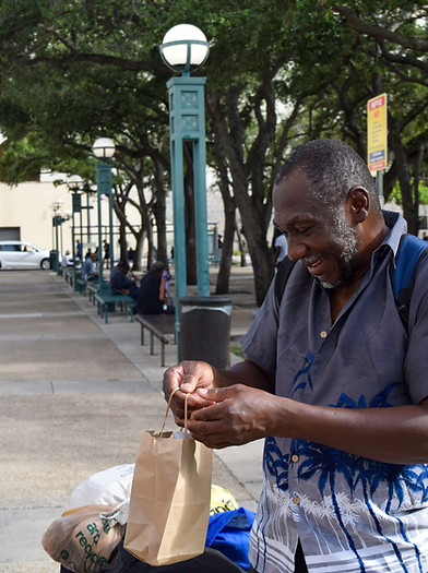 Homeless individual excited about the items we gave to him