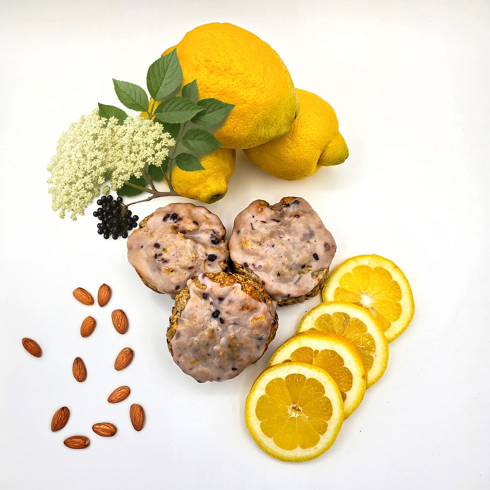 Elderberry, lemon almond scone on a table with lemons, almonds, and lemon slices
