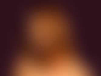 Model with glossy copper-chestnut hair in a blunt collarbone cut, photographed in warm light against a deep aubergine backdrop.