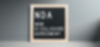 Framed black letter board with "NDA Non Disclosure Agreement" in white text, set against a gray wall and light wood floor.
