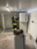 Two workers installing EcoChill unit