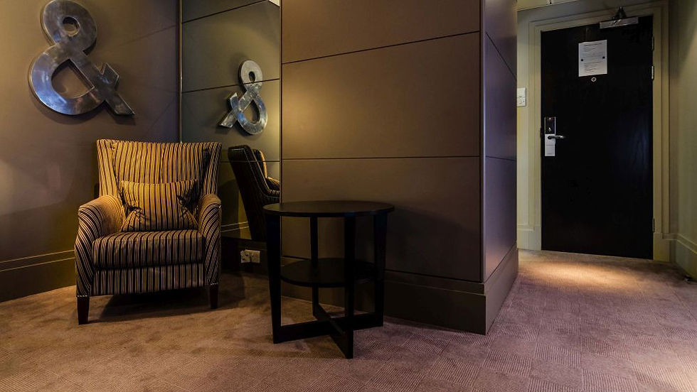 Cozy hotel seating area with armchair and table.