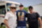 Eric Nelsen, director Raen LeVell and Glen Gould together behind the scenes of a Western film.