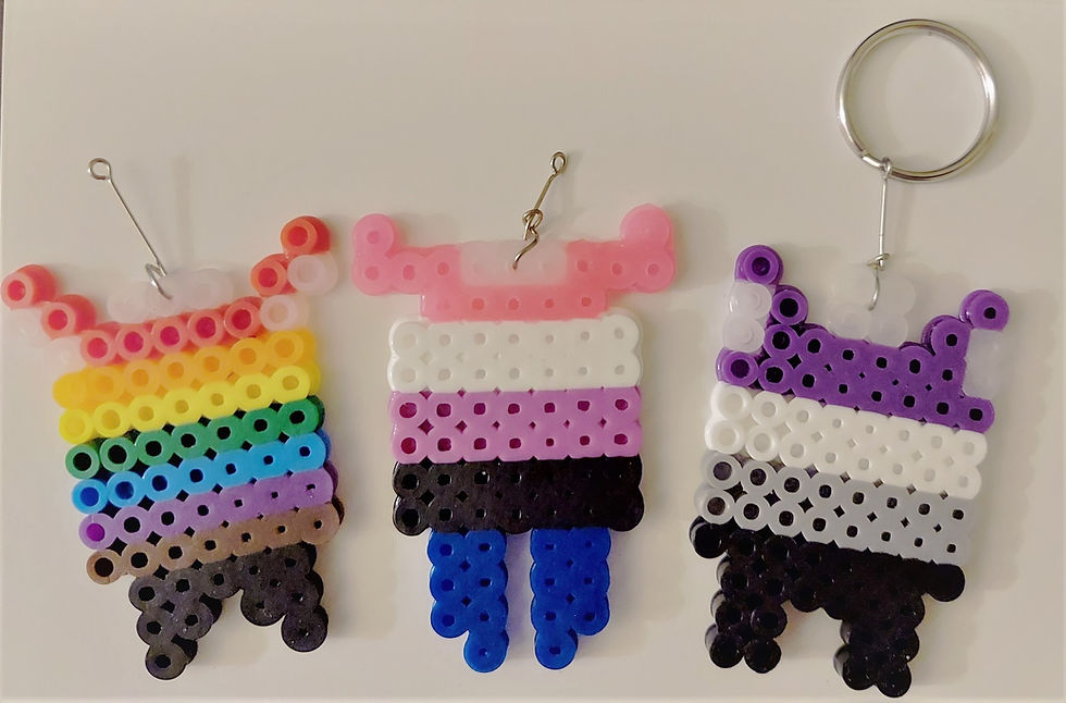 Perler art of abstract monsters. They use the pride colors, gender fluid colors, and ace colors from left to right.