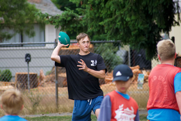 A Run To Win coach prepares to throw a pass during a flag football scrimmage.