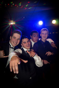 Group of friends posing for a party photo on the dance floor during a Christchurch DJ event.