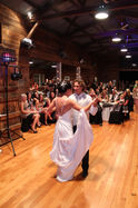 Reception space with draped staging and the Boogie Beats booth set for a North Canterbury wedding at The Woolshed at Tipapa.