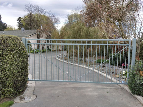 Pool style gate with every second bar going to the top powder coated and installed by Designer Gates Rangiora