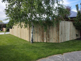 Pine fence with over and under overlapping vertical design installed by Designer Gates