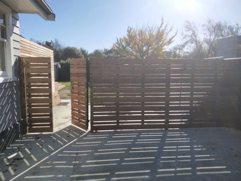 side gate and fence with timber attached to steel frame by Designer Gates in Chch