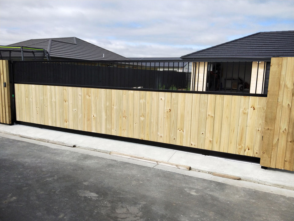Steel gate with a picture frame design and straight bars in the top with vertical pine in the bottom by Designer Gates Christchurch
