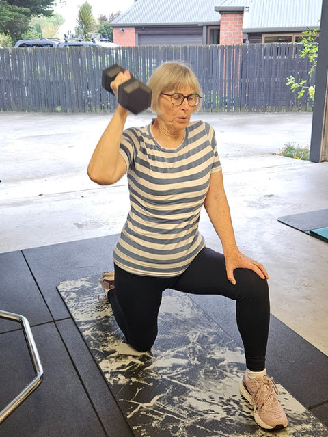 Mature woman doing strength training with dumbbell