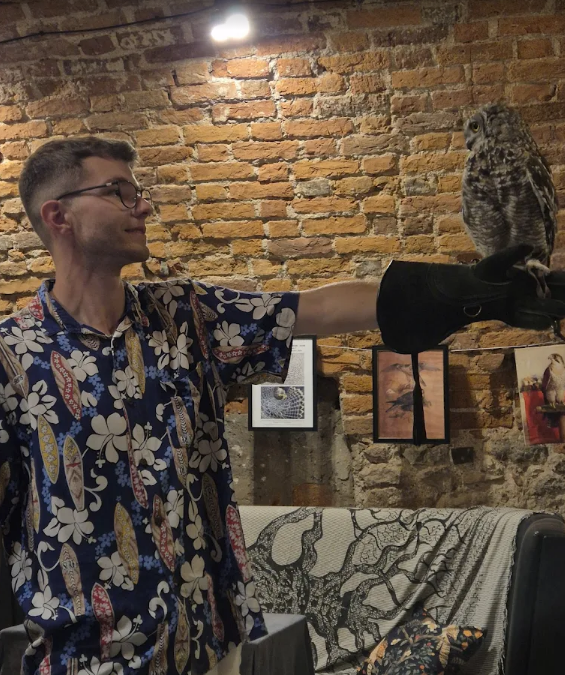 Guest holding the african spotted eagle owls and other birds of prey at the Owls Cave Experience Centre, Stolarska 11, Krakow, Poland a new popular tourist attraction in the centre of krakows old town, children and families and couples find it very interesting