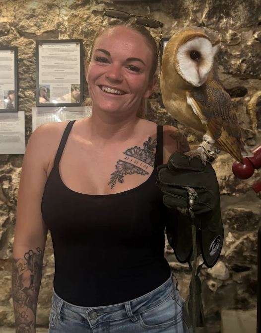 Guest holding the barn owl and other birds of prey at the Owls Cave Experience Centre, Stolarska 11, Krakow, Poland a new popular tourist attraction in the centre of krakows old town, children and families and couples find it very interesting