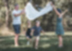 outdoor family photoshoot in melbourne. Kids running under a picnic blanket