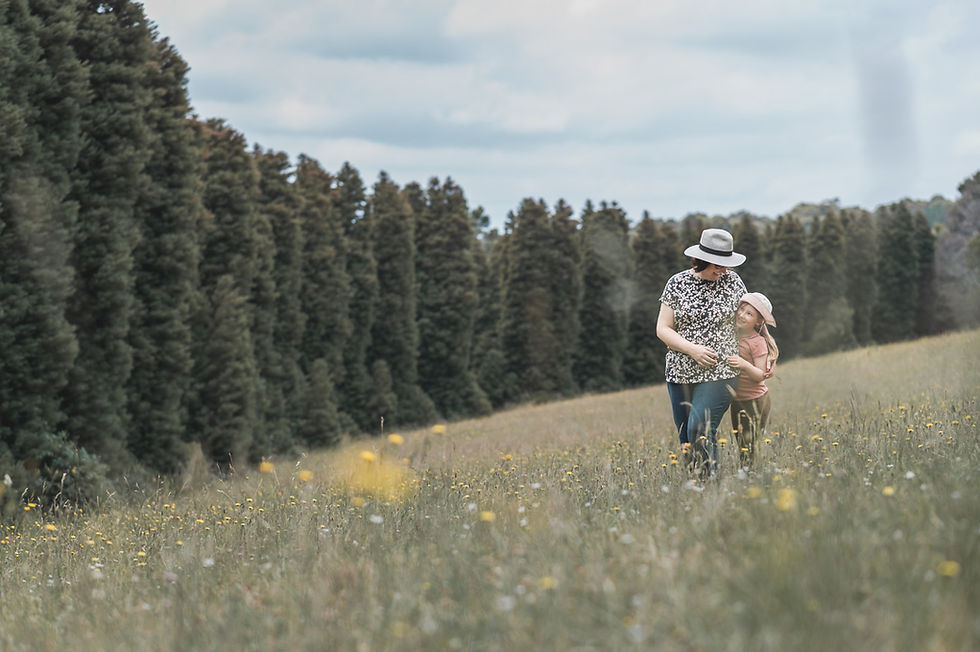 Melbourne Outdoor family photographer Gill Cook and her daughter are in a field of flowers at Olinda RJ Hammer Arboretum