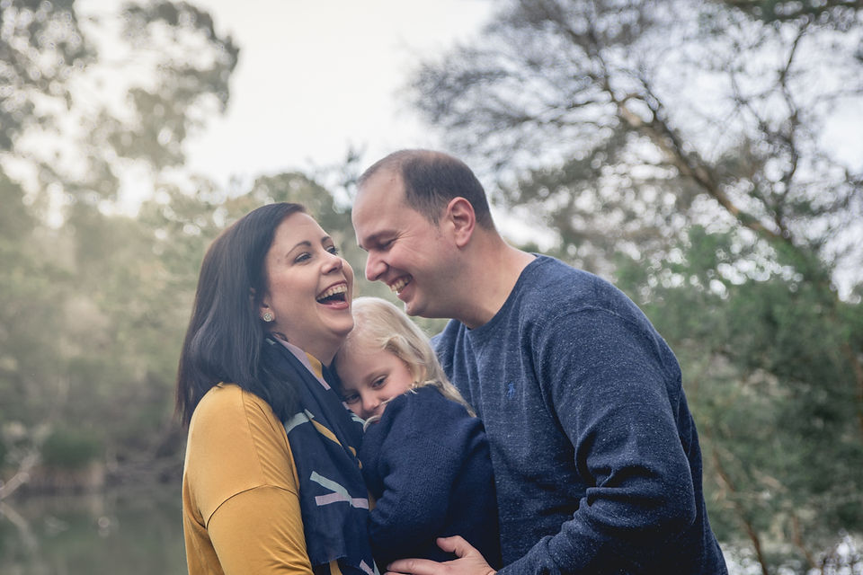 family of three laughing - lifestyle photo