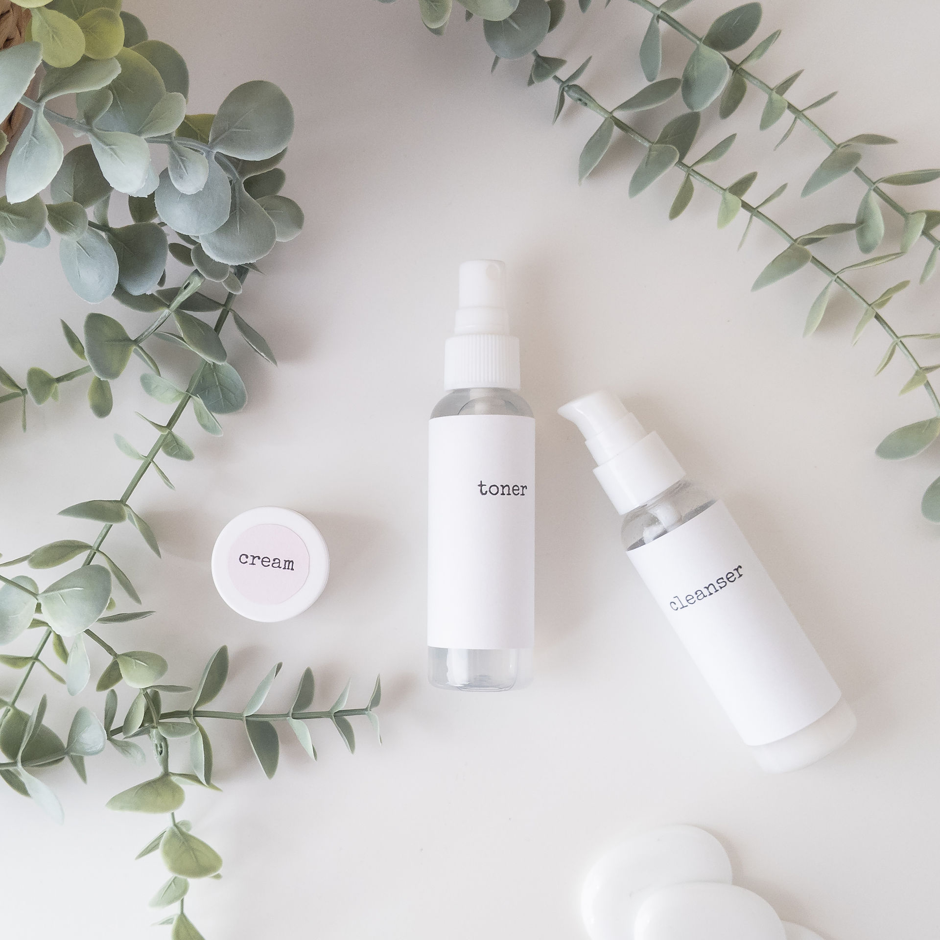 flat lay image of skincare range product photos styled with plant