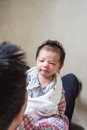 portrait of newborn above father - newborn lifestyle photography