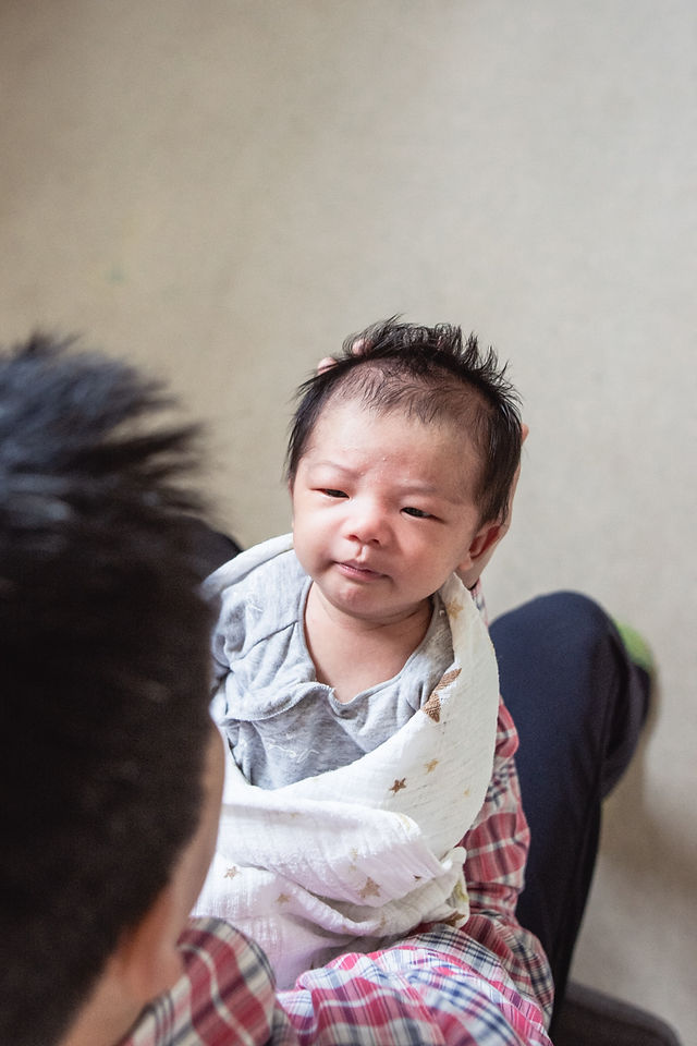 portrait of newborn above father - newborn lifestyle photography