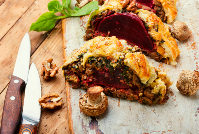 Sliced beet wellington with visible layers of filling.