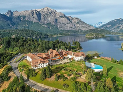 Aerial view of Llao Llao Hotel in Bariloche, Argentina, surrounded by lakes and mountains in Patagonia, showcasing eco-luxury in a pristine natural landscape.