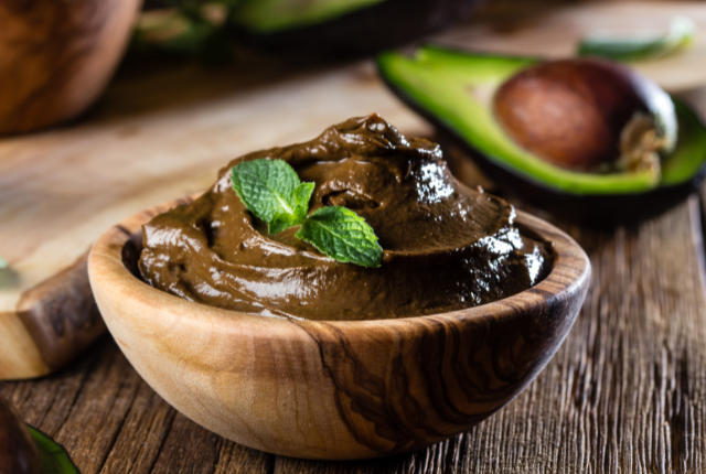 Rich chocolate avocado mousse in a wooden bowl.