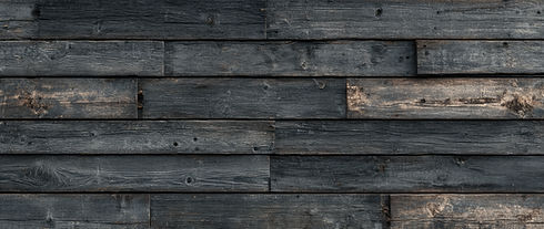 Weathered wood planks in a horizontal arrangement, providing a rustic background texture.