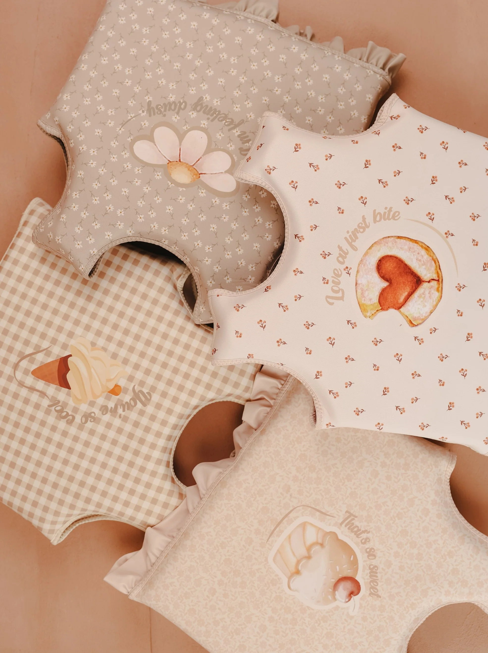 Multiple swim vests in neutral floral designs for girls