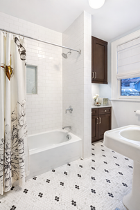 Renovated bathroom with tile installation and modern fixtures.