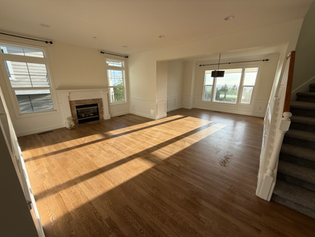 Living room with newly installed hardwood flooring.