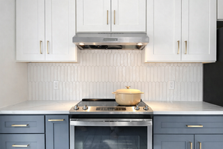 Modern kitchen backsplash tile installed behind countertop and cabinets.