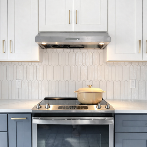 Kitchen backsplash with white vertical picket tile behind stove and cabinets