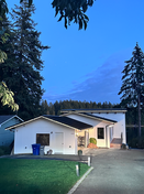 House decorated with holiday roofline lights at night