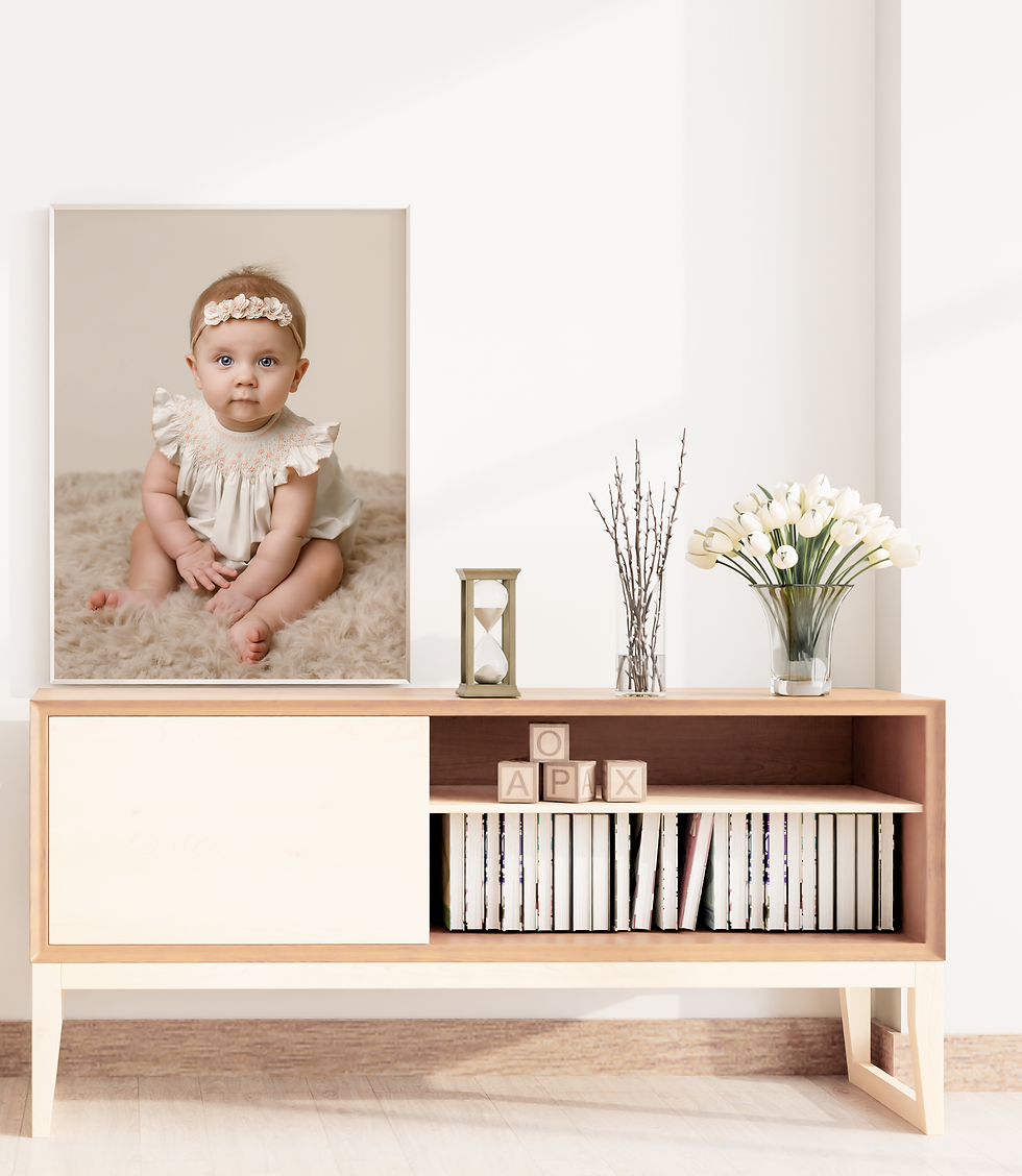 Portrait of a baby girl hung above a bookshelf in a nursery.