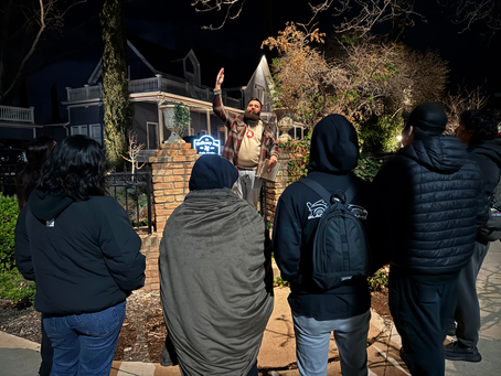 St. George Ghost Tour Guide giving guided walking tour to 4 people in front of mulberry inn
