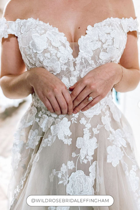 Close up of bodice of off-shoulder Eddy K ballgown with lace over tulle