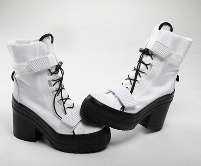Studio product photograph of black and white Converse boots photographed on a clean background.