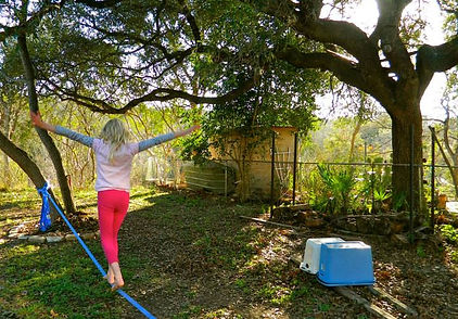 Little girl walks a slackline by herself during a Slackline Class.
