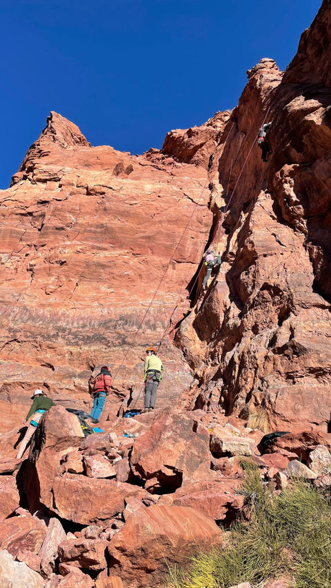 Guided Climbing Moab: A group climbs red desert rock in Moab. Learn the basics of climbing, moving your body on rock, belaying and keeping another climber safe, and lowering from the top. Our AMGA certified guide will keep you safe and tailor the instruction to expand on what you know!