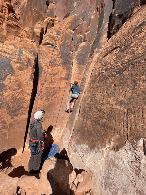 Guided Climbing Moab: A group climbs red desert rock in Moab. Learn the basics of climbing, moving your body on rock, belaying and keeping another climber safe, and lowering from the top. Our AMGA certified guide will keep you safe and tailor the instruction to expand on what you know!