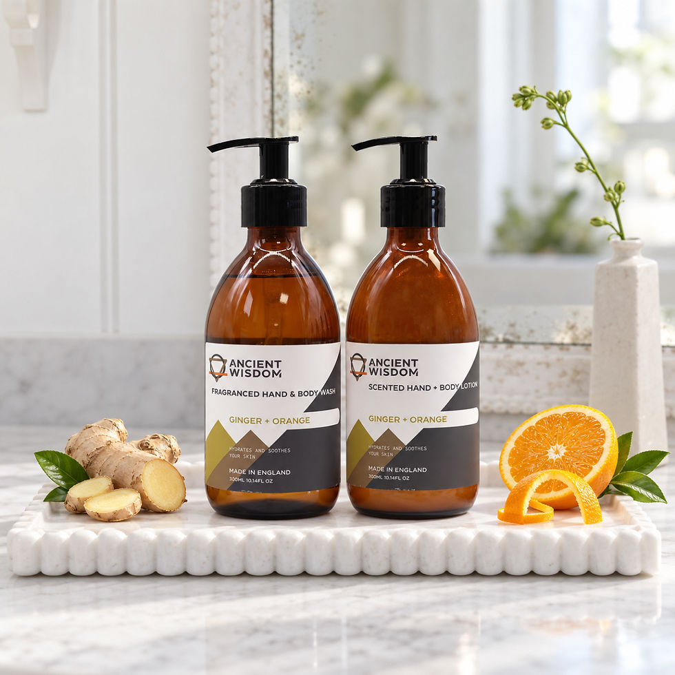 Ancient Wisdom Ginger and Orange hand and body wash and lotion styled together on a pale marble tray with fresh orange ginger