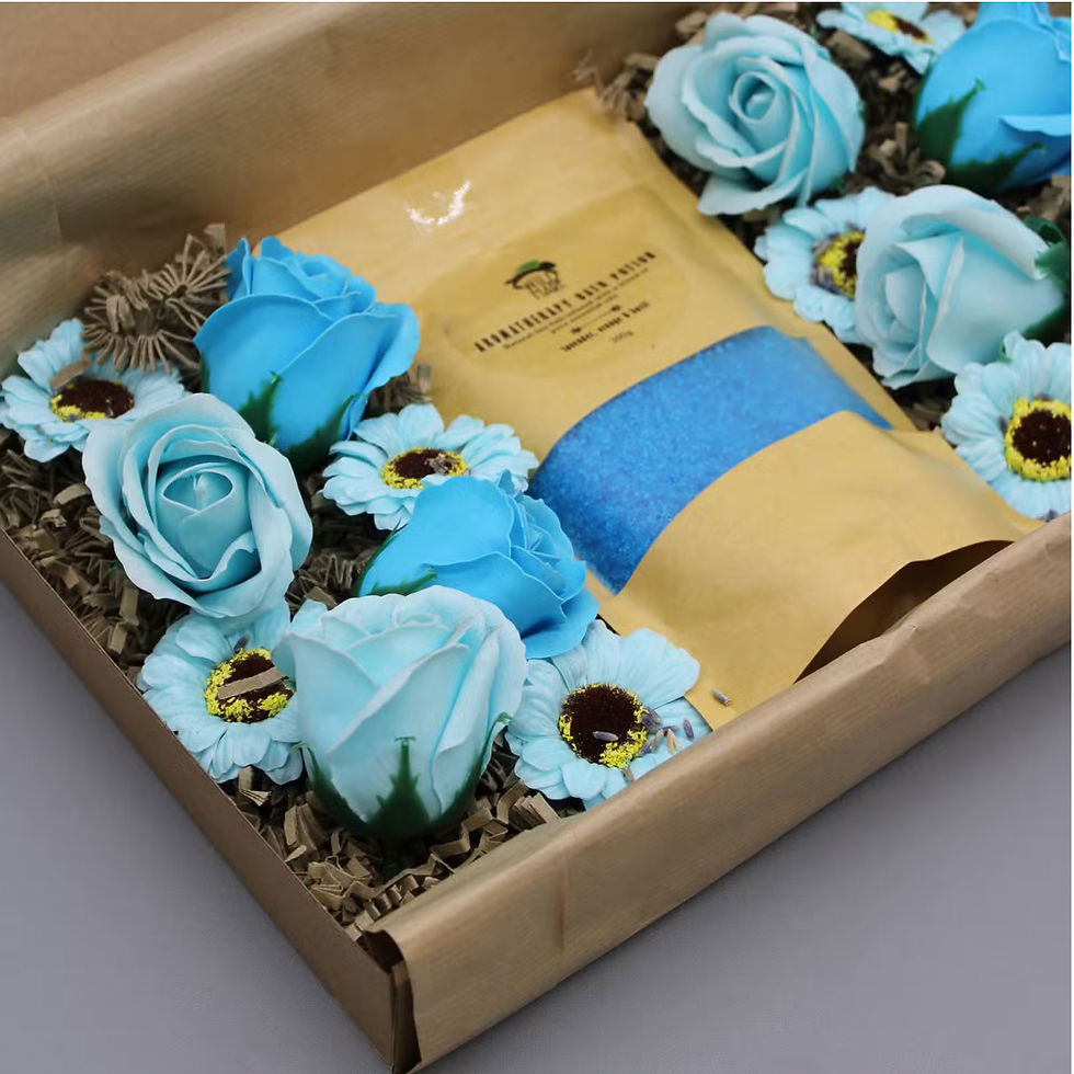 Lavender Dusk aromatherapy bath gift set with blue flowers styled on white hotel towels in a country house guest room
