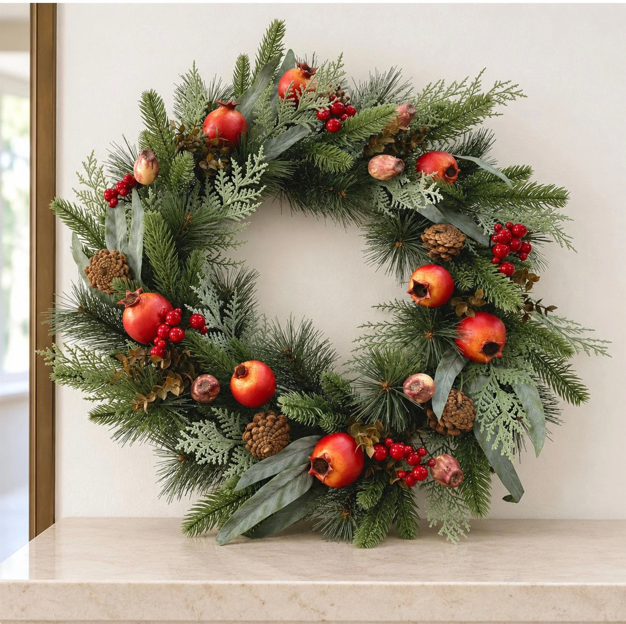 Artificial pomegranate and red berry Christmas wreath with pine and cedar foliage