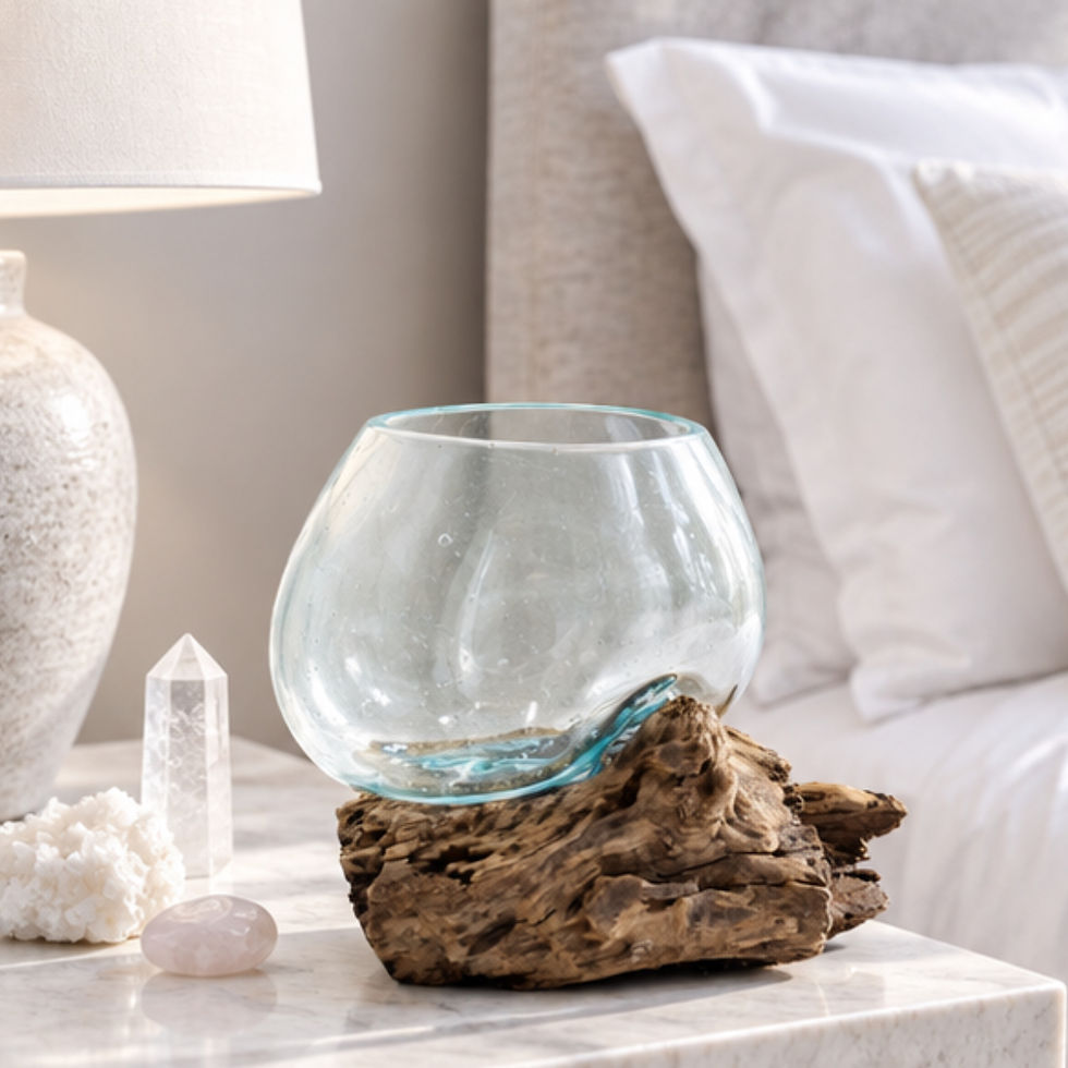 Molten Glass Bowl on Dark Wood – Medium recycled molten glass vessel shaped over natural wood set beside a bed
