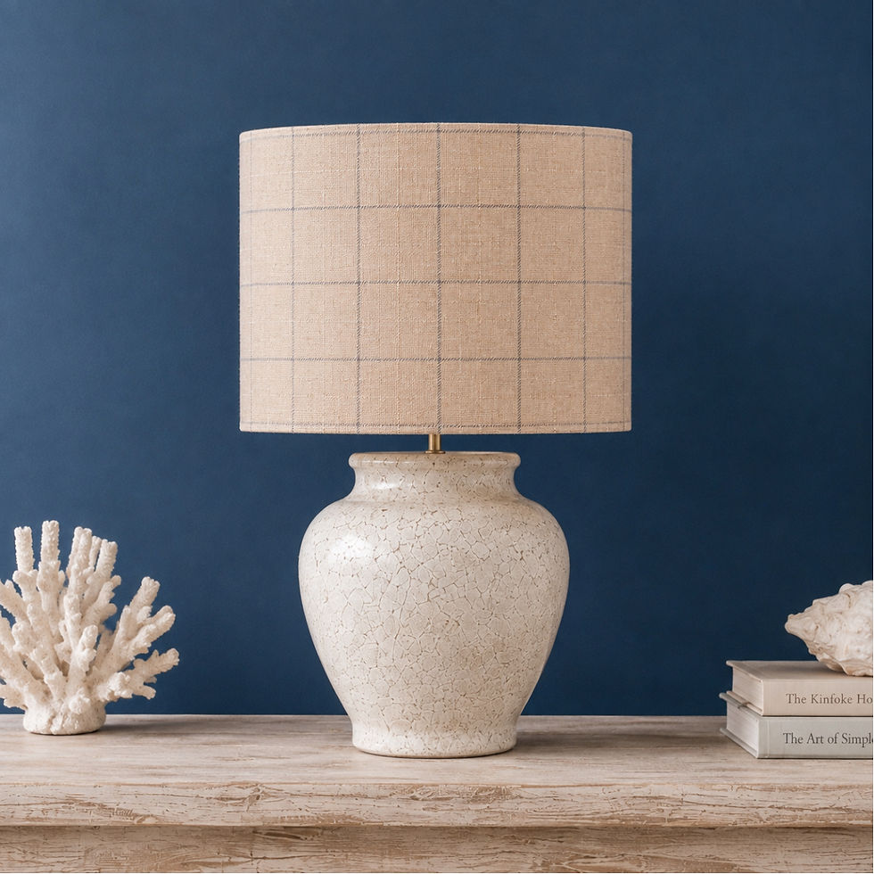 Thumbnail: Handmade Kintyre Millet wool drum lampshade with a fine blue-grey check, styled on a cream ceramic table lamp.