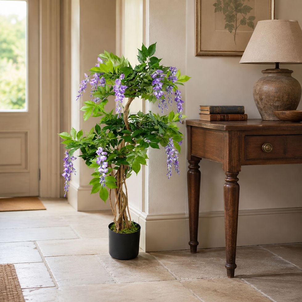 Purple artificial wisteria in a decorative planter beside a painted dresser in a country-house interior.